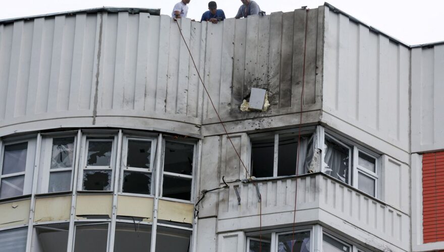 Men are seen on the roof of a damaged multi-storey apartment block following a reported drone attack in Moscow, Russia, May 30, 2023. REUTERS/Maxim Shemetov